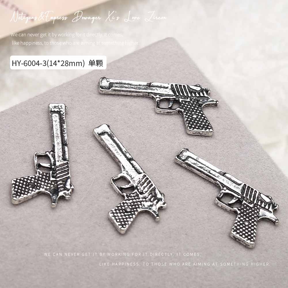 Europa y los Estados Unidos en línea con diamantes AK armas de manicuría joyas de simulación de personalidad tridimensional armas de fuego decoración de uñas al por mayor