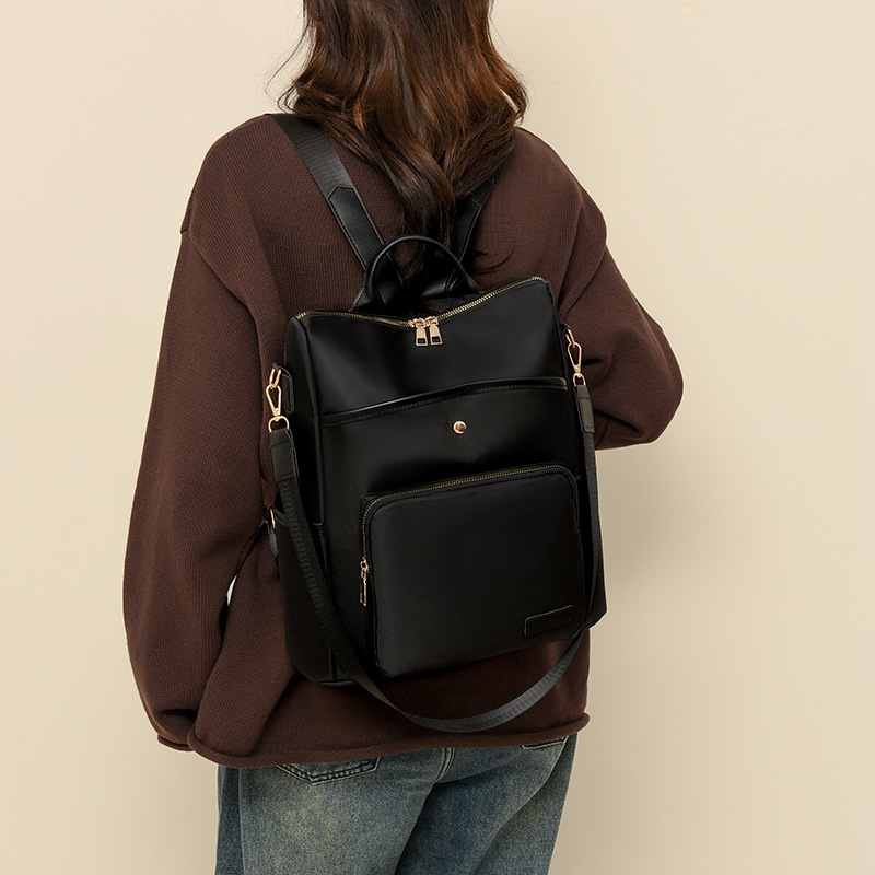 Mochila de tela Oxford nueva transfronteriza para mujer Mochila de moda estilo coreano retro mochila de viaje de moda con remaches simples