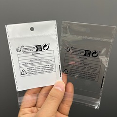 Two hundred new Temu French triman eco-label and PP5 suffocation prevention labels in OPP plastic bags bundled together