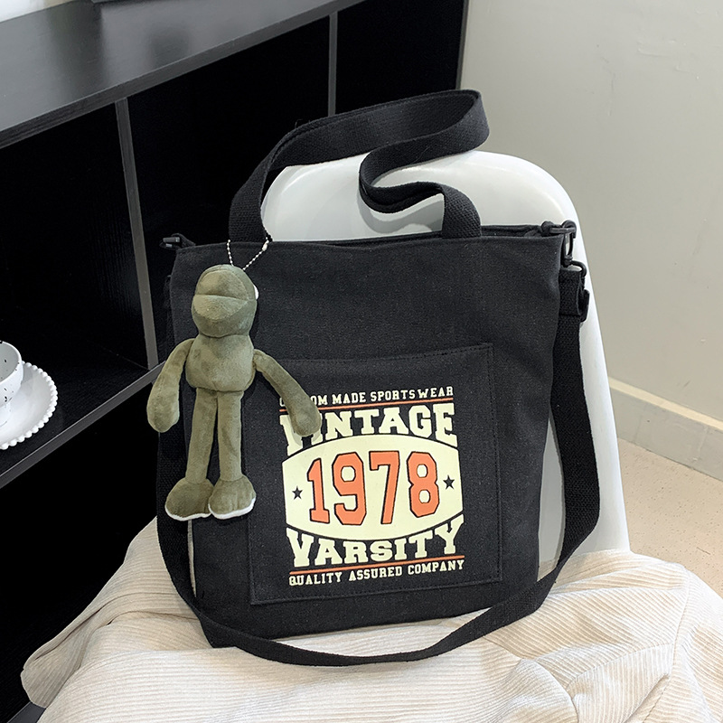 Comercio exterior engrosada bolsa de lona para hombres y mujeres misma gran capacidad estudiante retro bolso de escuela bolsa de hombro bolsa de mensajero