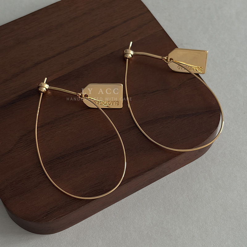 Engraved metal tag water drop large hoop earrings, shiny gold urban style earrings, niche design earrings for workplace wear