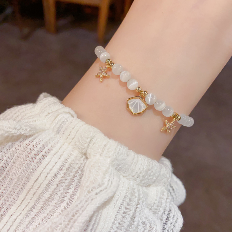 Pulseira elegante em pedra olho de gato com concha e estrela_voghion.com