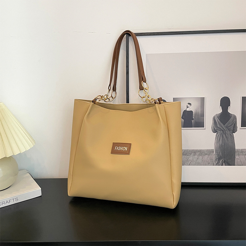 Este año, la textura Popular de gran capacidad tote paquete para mujeres 2024 nuevo paquete de clases para estudiantes de ocio de moda de moda paquete de cercanías