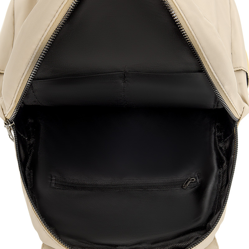 Mochila de color sólido para mujer 2025 moda coreana simple y salvaje mochila de tela Oxford mochila de viaje de ocio para mujer al por mayor