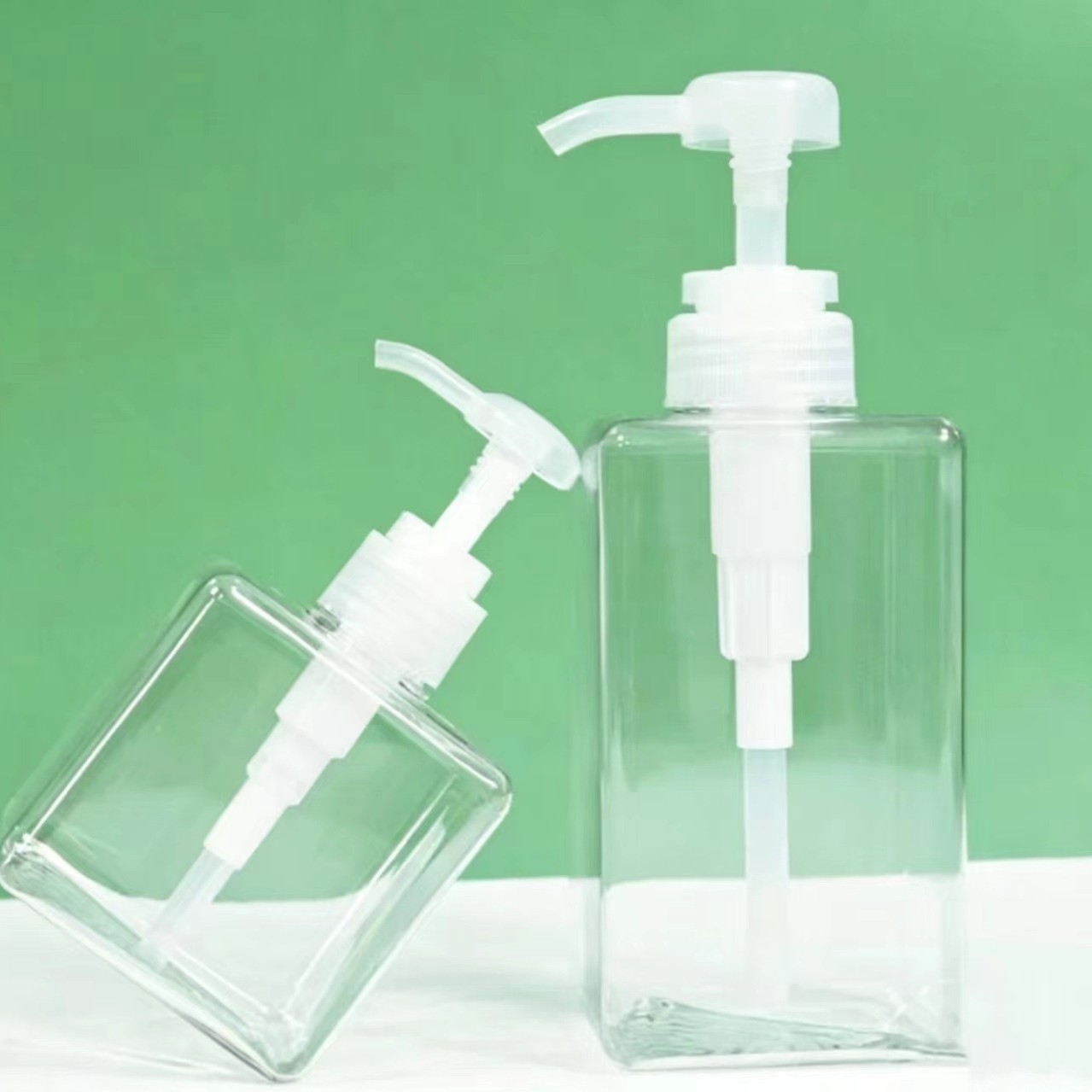 Transparent square press bottle for hand sanitizer, shower gel, and shampoo dispensing