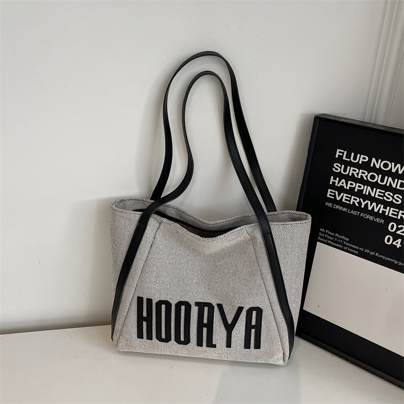 Bolsa de lona de gran capacidad para viajes 2025 nueva bolsa de mujer bolsa de hombro casual estilo exterior versátil bolso universitario