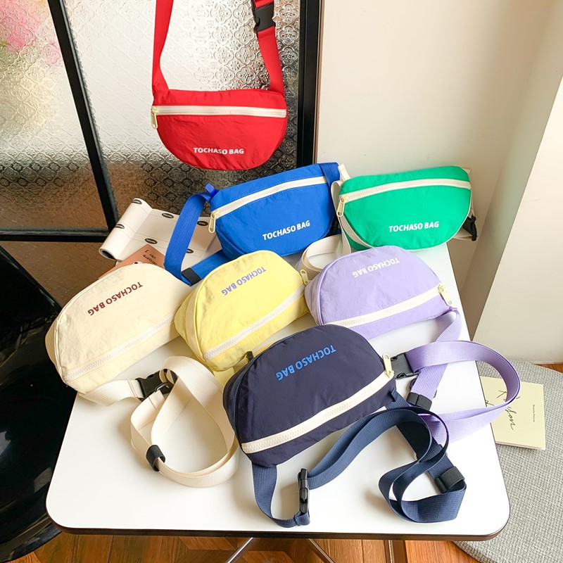 Moda coreana popular para niños y niñas bolsas de cintura letras extranjeras bolsas de mochila para bebés 2026 nuevo bolso de cambio para niños