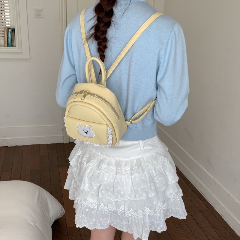 Mujeres nuevas estilos de dibujos animados simples estudiantes 2026 verano universal mochila ligera oso mochila encantador viaje coreano