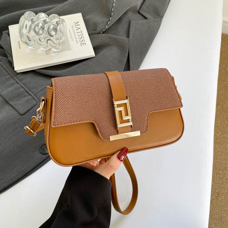 Nicho de diseño de alta sensación de silla de montar bolso para mujeres 2026 nuevo estilo coreano simple brazo de moda de hombro pequeño bolso