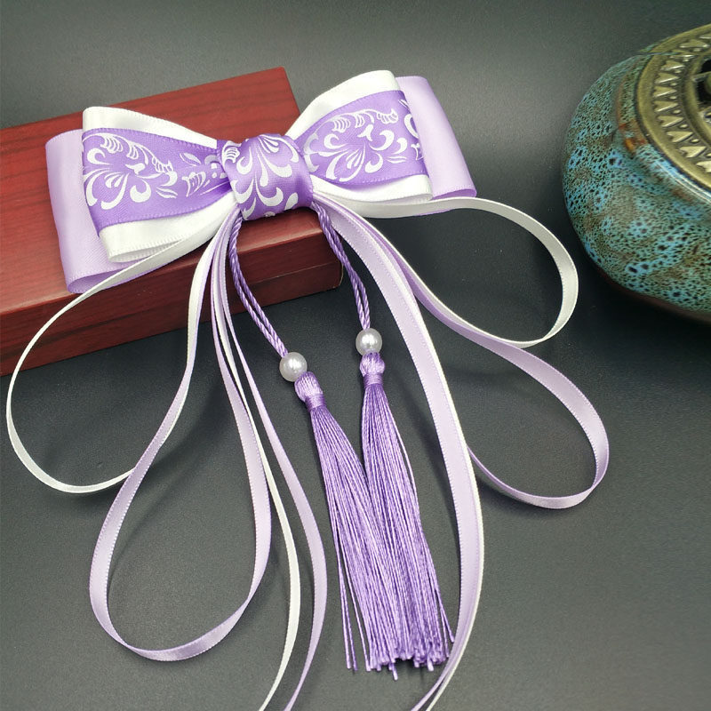 Elegant blue and white hairgrip with tassels