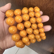 直播展会厂家直供二代老鸡油红漂花琥珀蜜蜡手串荧光浮水男女款