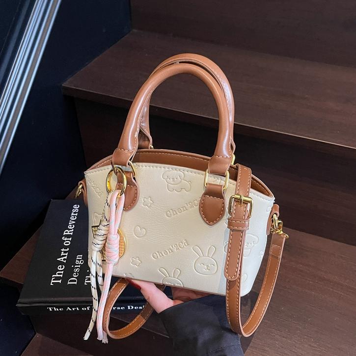 Tendencia nicho bolso de mano de moda mujer 2025 nueva textura versátil bolso de cubo bolso de transporte aéreo