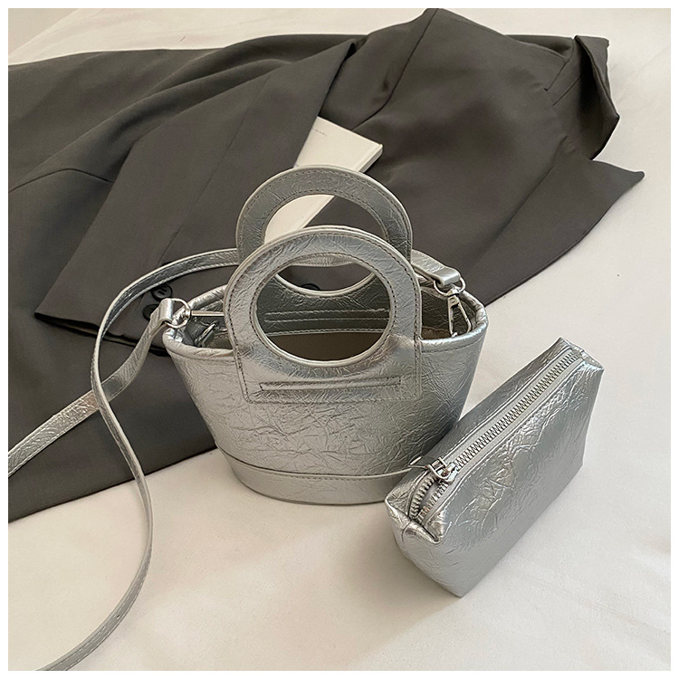Bolso para mujeres 2026 nuevo nicho coreano de comida de mano cesta bolsa de cubo de textura alta de viaje mochila de hombro