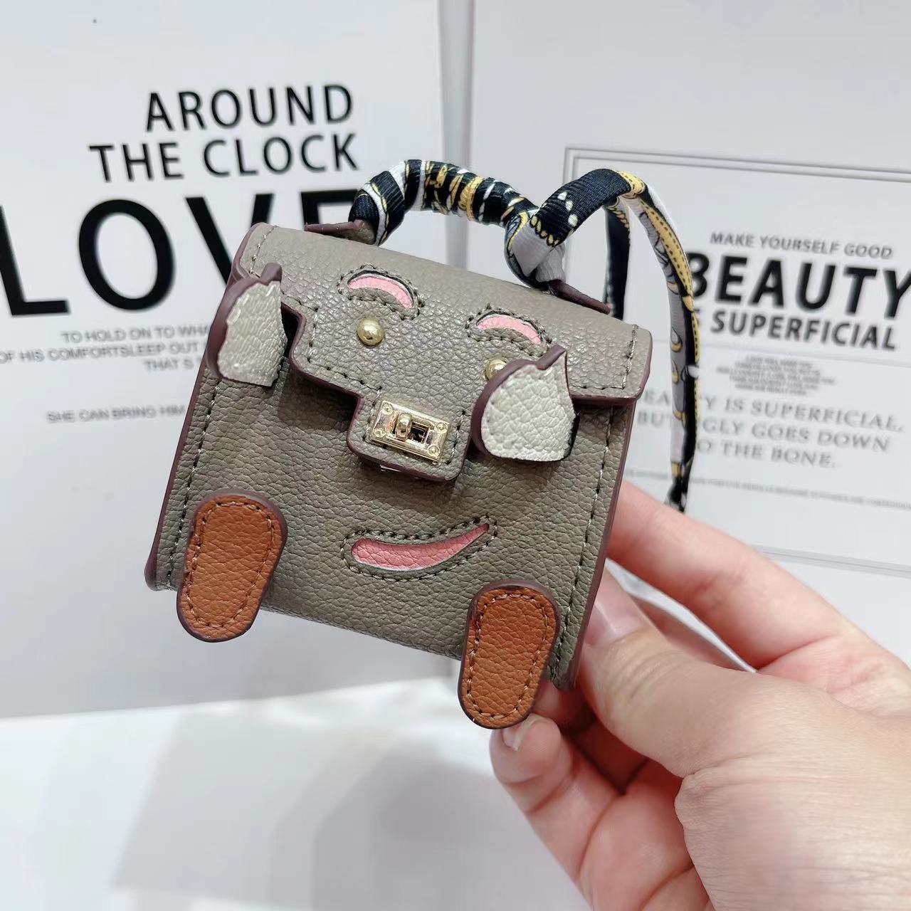 Lindo mini bolso de muñeca Kelly personalidad de nicho auricular Bluetooth inalámbrico bolso universal colgante pequeño premium marca de moda mujer