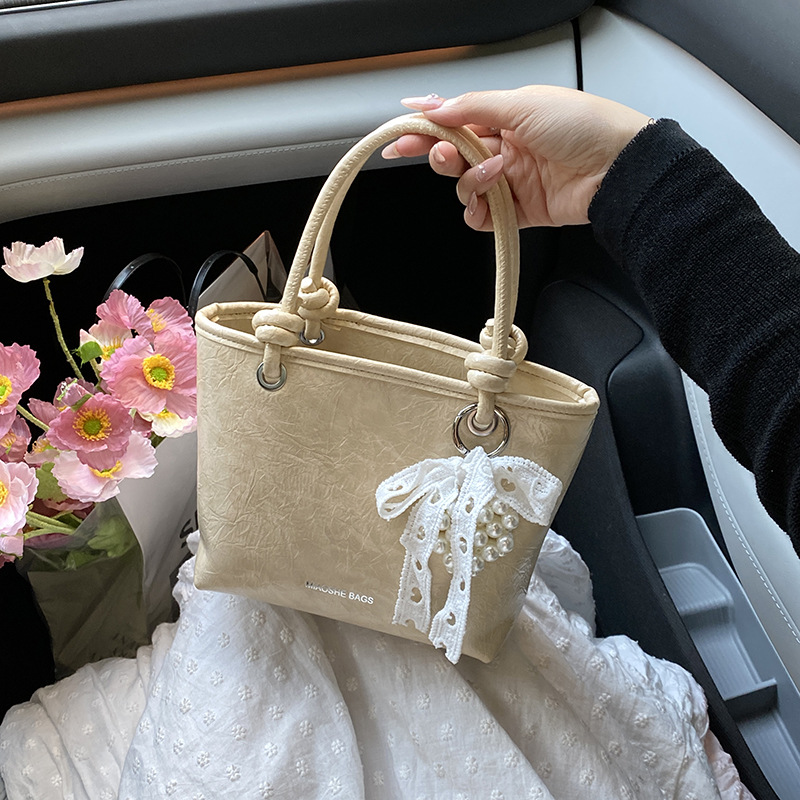 Bolso de mujer PU al por mayor transfronterizo 2025 nuevo bolso de mensajero de un solo hombro casual simple bolso de cubo de agua súper caliente de alta gama de verano