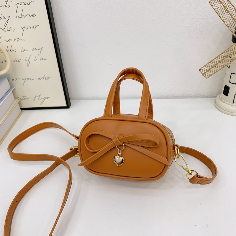 Coreano simple color sólido bolso de hombro para niños y niñas mini bolso de bebé lindo dulce bolso de arco para niños