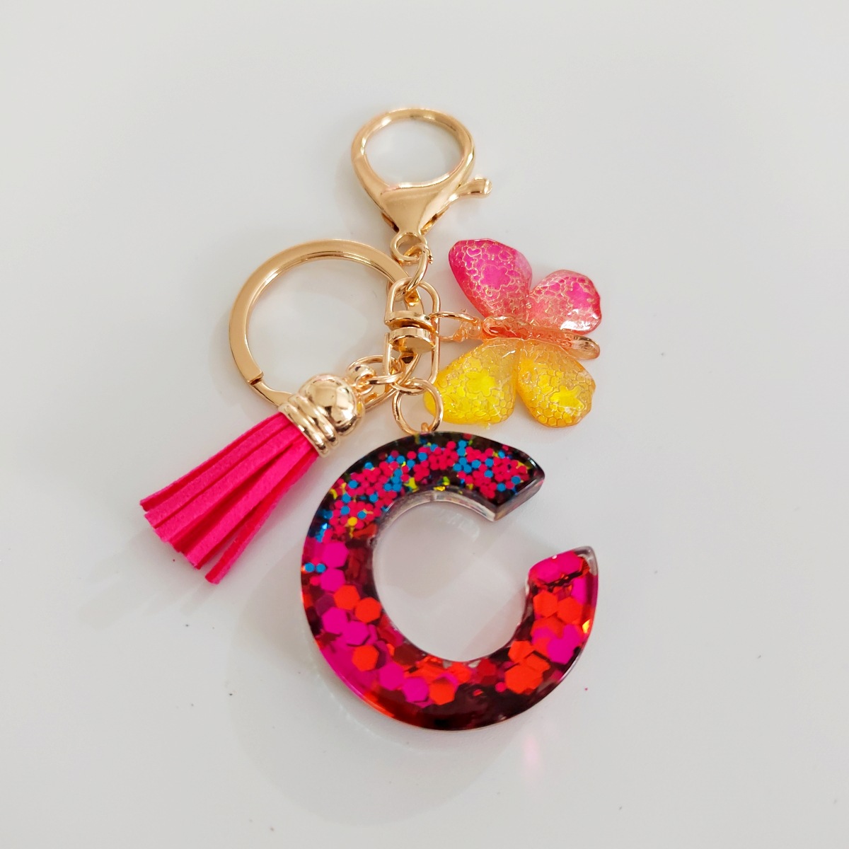 Ventas transfronterizas calientes de letras inglesas de color mixto colgante de llavero colgante de mariposa fringe de resina de llavero colgante de joyería