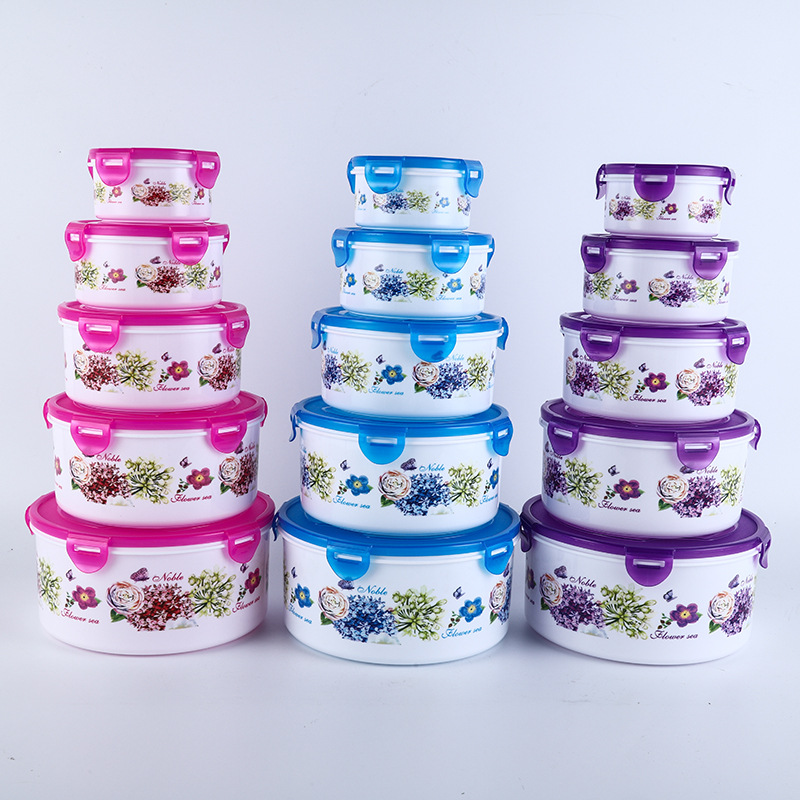 Caja redonda hermética para almacenamiento de alimentos, ideal para refrigerador, camping o uso doméstico.