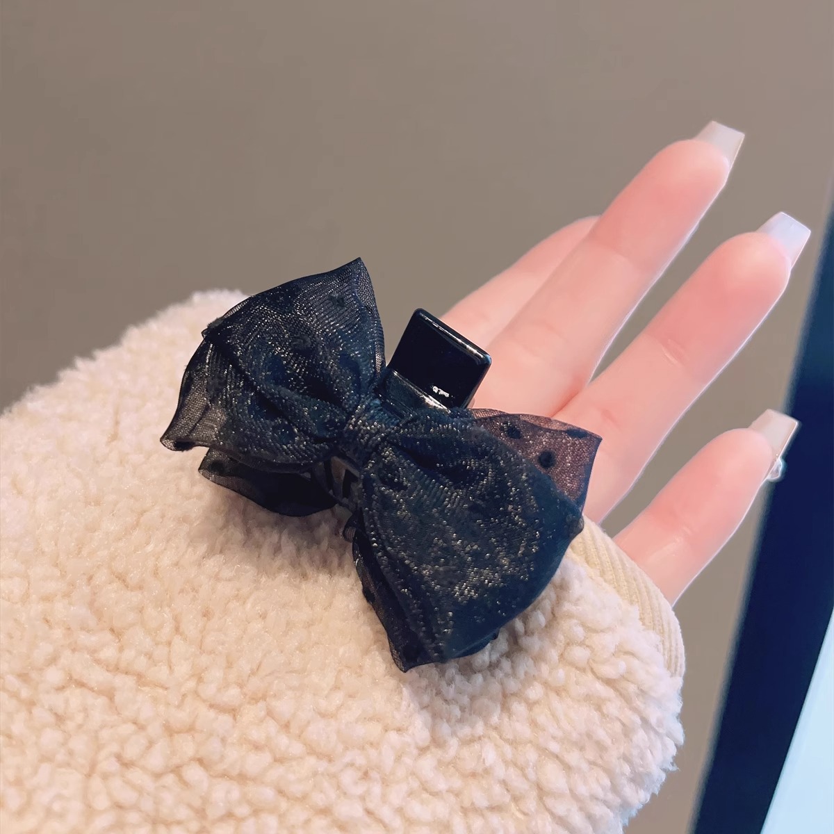 Black double-sided crab pin with bow