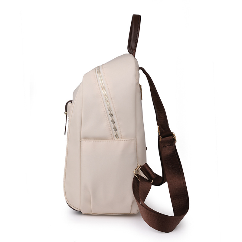 Spot al por mayor 2023 nueva mochila de nailon para mujer coreana moda contraste color al aire libre mochila de viaje portátil marea