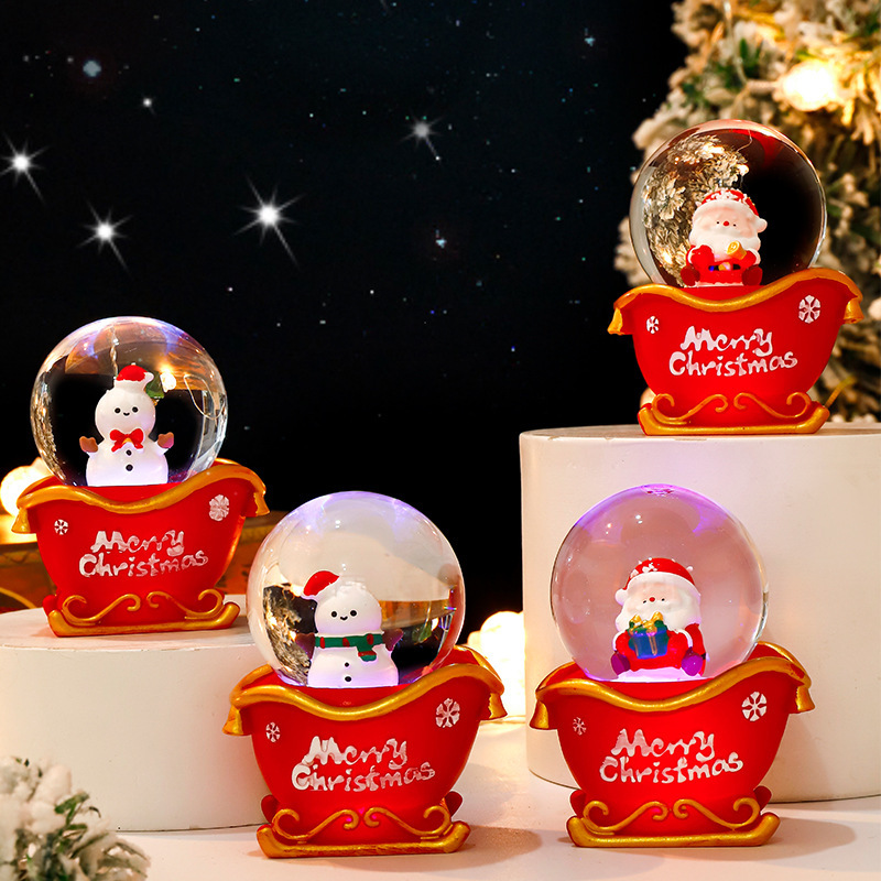 Una variedad de bolas de cristal luminosas de dibujos animados lindos creativos, adornos decorativos explosivos, regalos navideños, bolas de cristal con luz al por mayor