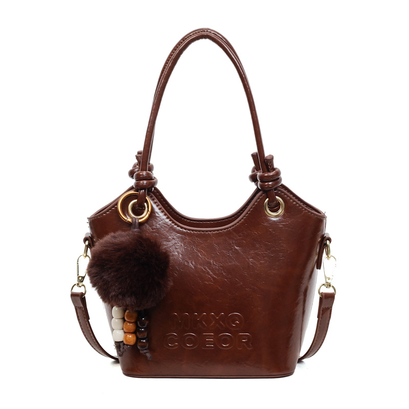 Retro alta sensación de bolso de cubo de mano 2025 invierno nuevo ocio versátil bolso de hombro de viaje mochila de mujer