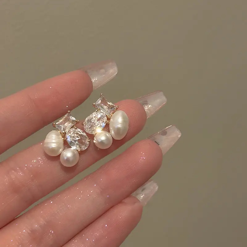 Design elegant earrings from pearl with zircon