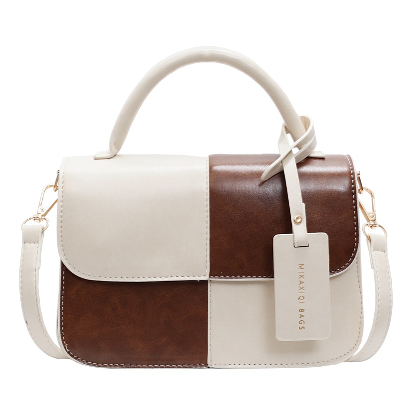 Bolso de mano coreano de color para mujeres 2025 nuevo nicho de textura universal bolso de hombro simple mochila casual