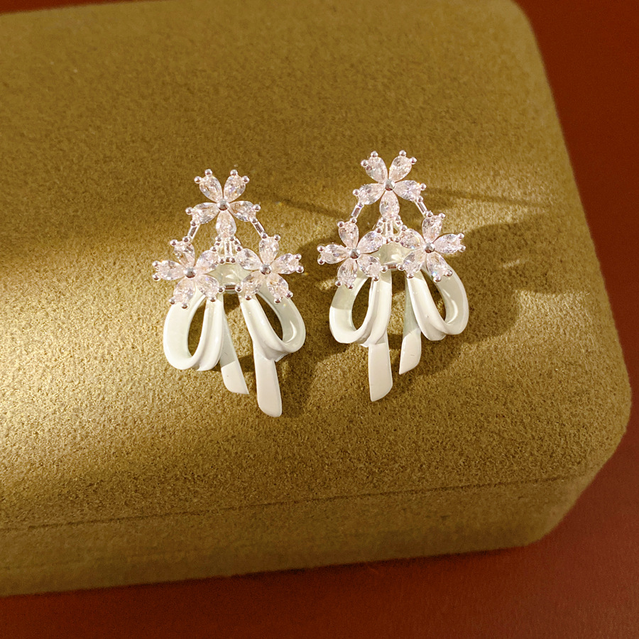 Aguja de plata goteando aceite de zircon flores arco pernos temperamento moda aretes dulces ligero lujo alta sensación de auriculares al por mayor