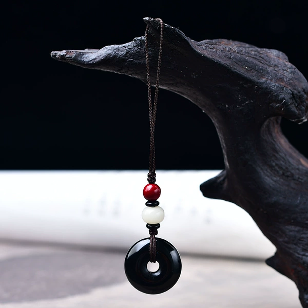 Protective amulet, buckle, mobile phone