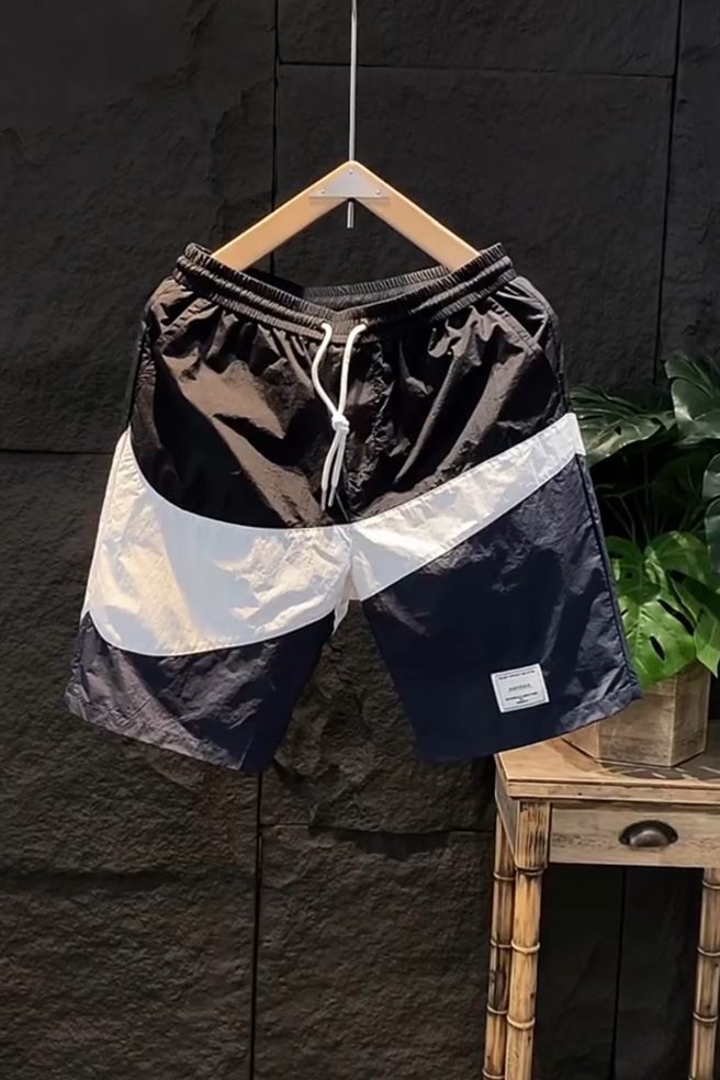 Pantaloncini estivi con etichetta di moda abbinati a colori casual larghi e versatili per pantaloncini da spiaggia sportivi ad asciugatura rapida da uomo_voghion.com