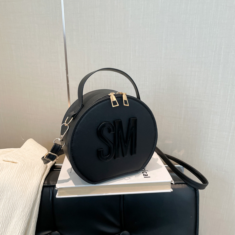 2025 primavera nueva impresión de letras de moda redondas personalidad simple nicho ocio mochila de tendencia de mujer viaje