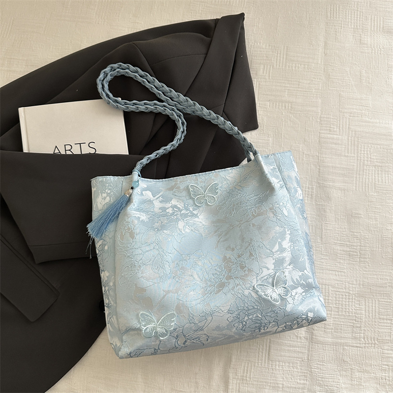 Bolso de viaje de seda de mariposa de alta calidad de nicho 2025 verano nuevo bolso de mujer simple de gran capacidad nuevo estilo chino