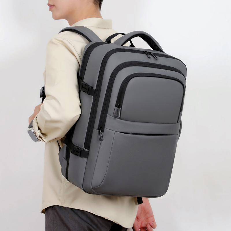 Mochila simple de color sólido de gran capacidad para hombres con capacidad de expansión multi-compartimiento USB colgando varilla de tracción mochila de viaje