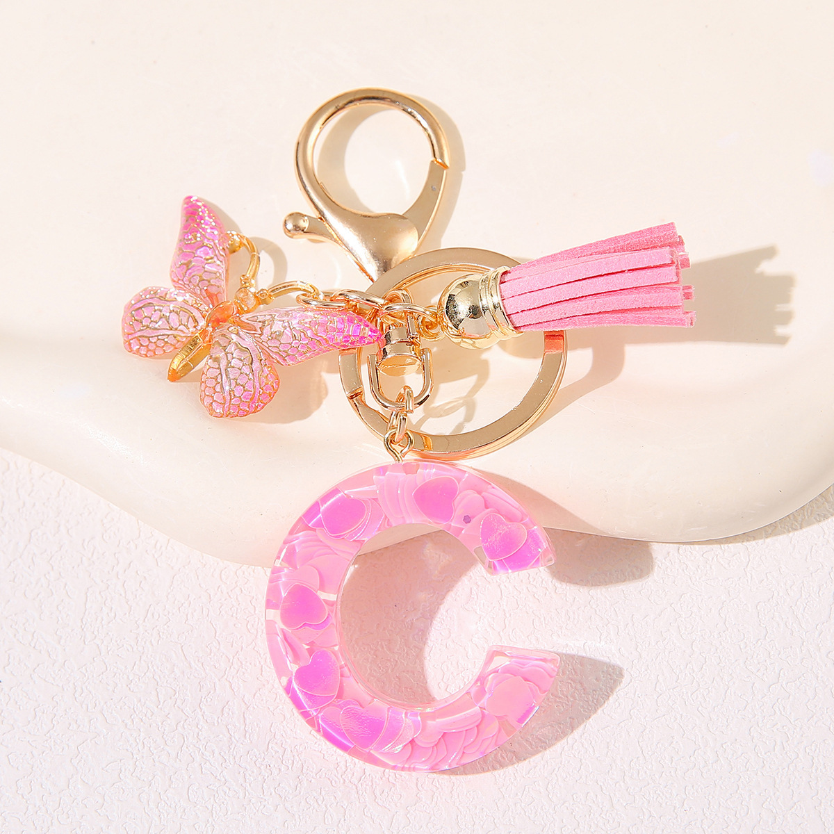 Nuevo rosa damas letras A-Z llavero de goteo de goma sequilla amor letras bordas mariposa llavero transfronterizo