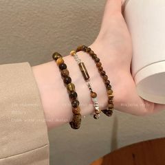 銀貨を砕く虎眼石は数珠をつなぎ合わせて女性の秋冬の金の小さい大衆の復古の手をつないで学生のカップルの個性のブレスレットを飾ります。