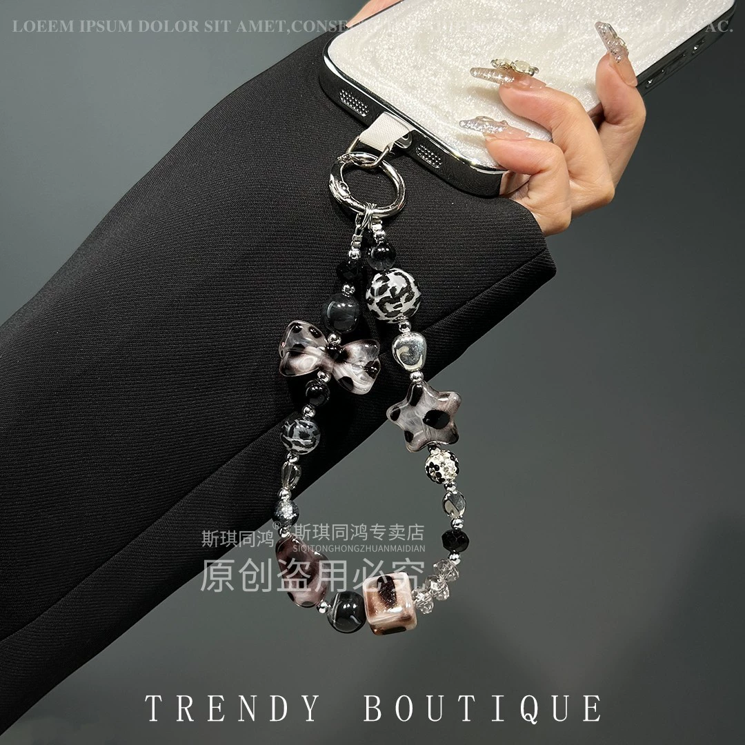 Mobile phone with bow, strap, sophisticated bracelet, pendant