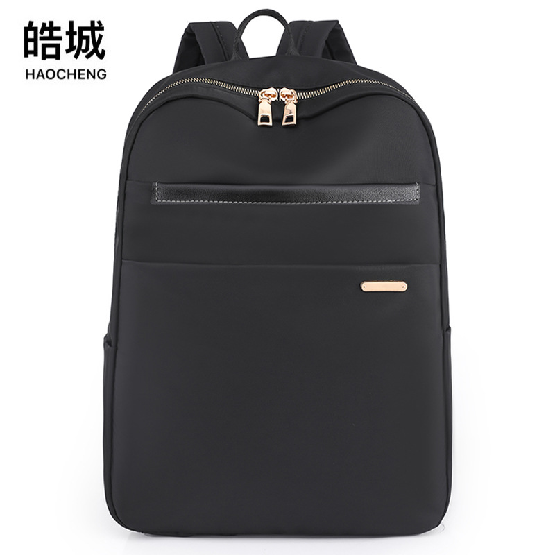 2023 nueva mochila de nailon para mujer de gran capacidad simple y versátil mochila de computadora para estudiantes de secundaria al por mayor
