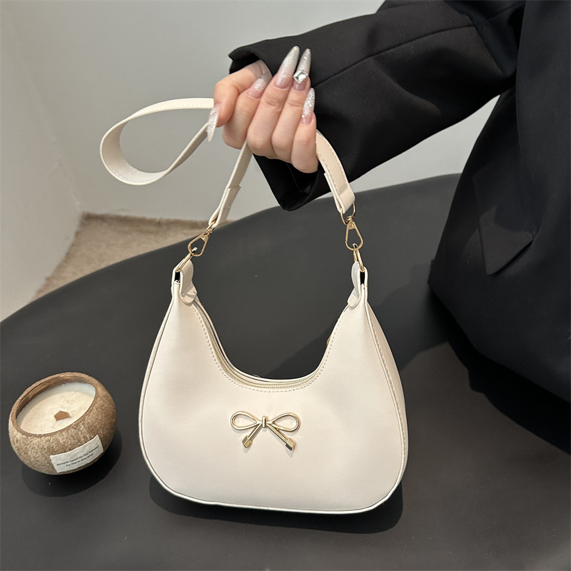 Sensación de la axila bolso pequeño mujer 2025 primavera nueva moda todo-fósforo bolso de hombro diseño de nicho bolso de palo francés mujer