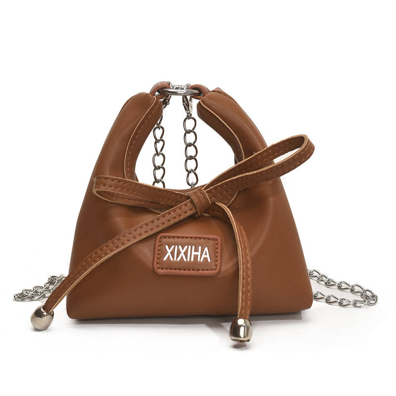 Bolsa de tendencia coreana para niñas, mini bolso de mano simple de color sólido, bolso de accesorios para niños de arco lindo