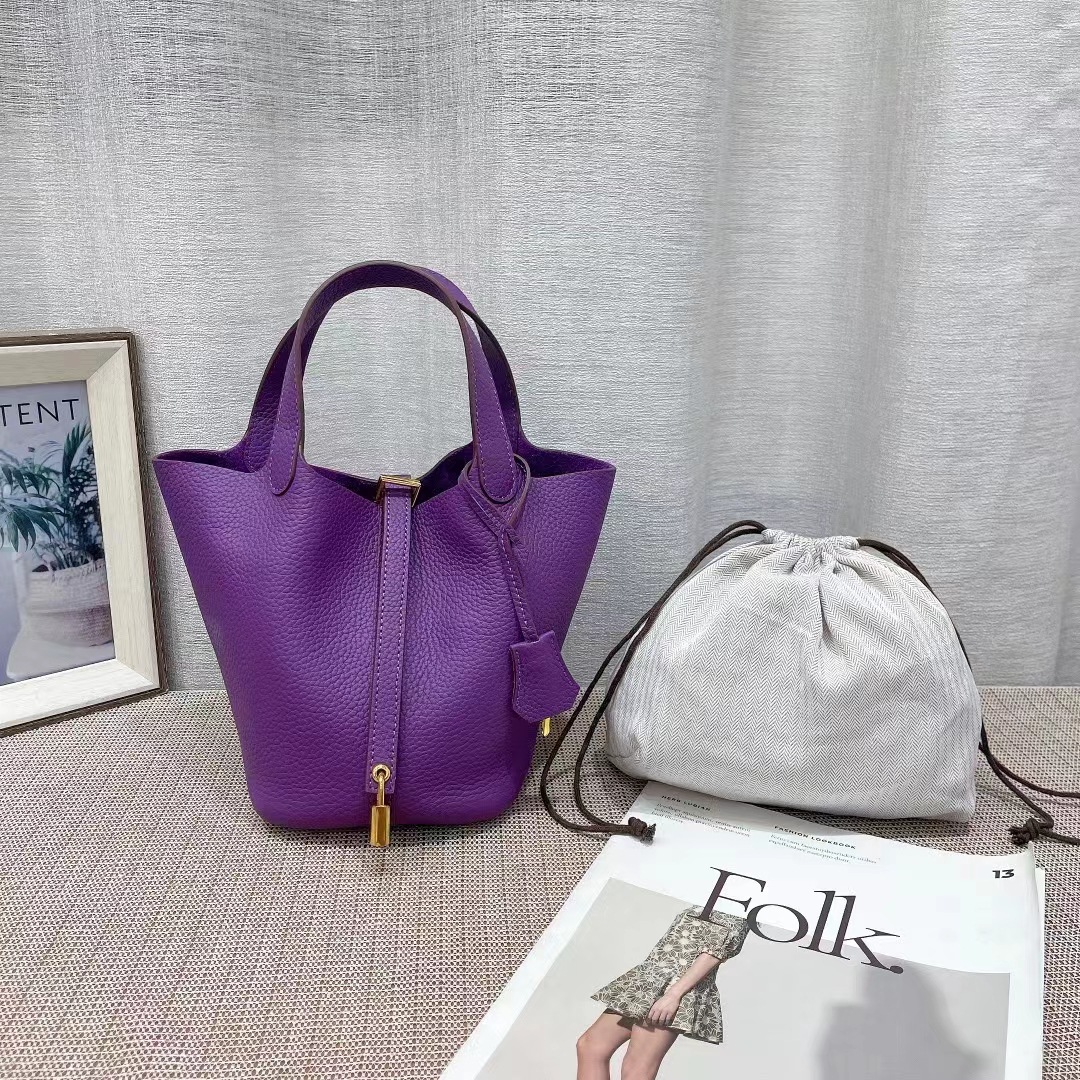 El nuevo bolso de cesta de verduras de marea de cuero togo de piel de vaca de capa superior 2025, bolso de cubo con cerradura de mano, bolso de cuero para mujer