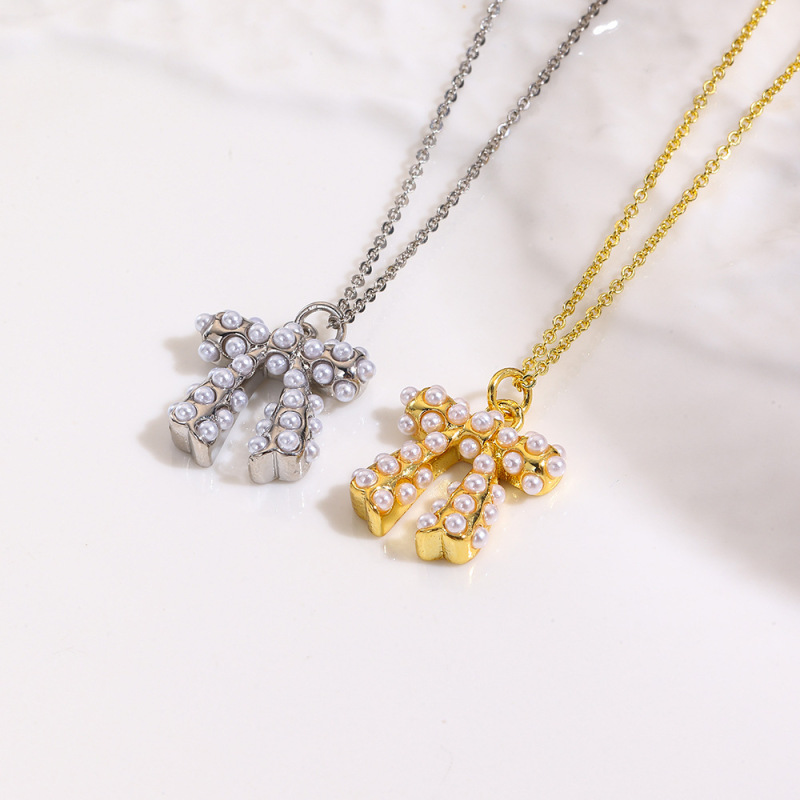ヨーロッパとアメリカのファッショナブルな銅メッキ 18K 象嵌模造パールリボンネックレスペンダントイヤリング 3 点セット装飾|undefined