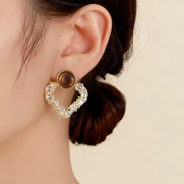 Retro-style, lightweight, and luxurious cat-eye stone and silver geometric earrings. These high-end, small, square-shaped earrings with diamond accents offer a unique and elegant look