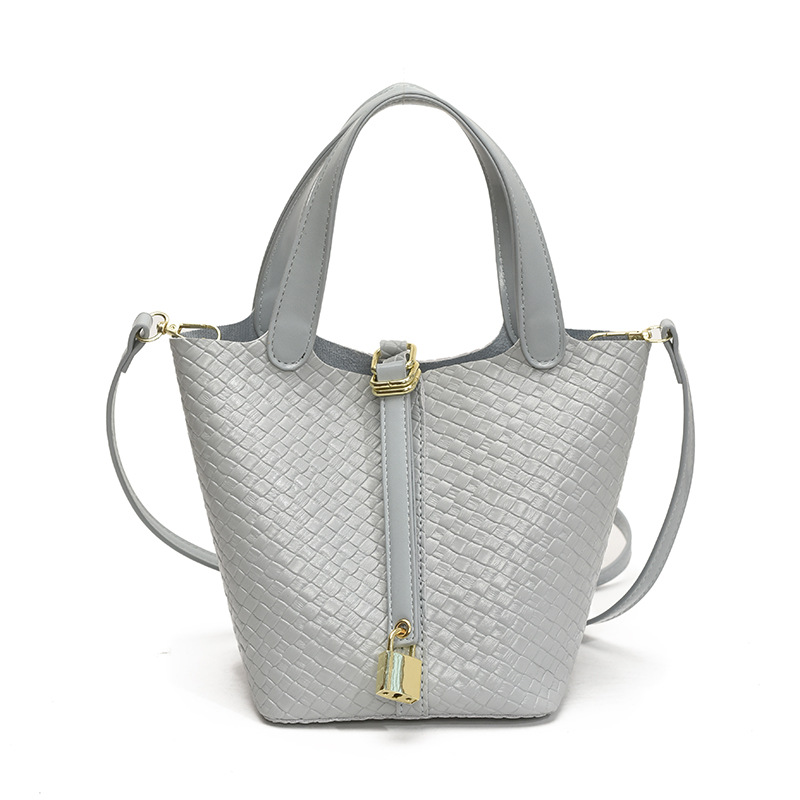 Bolso de cubo portátil con patrón tejido para mujer 2025 nuevo estilo coreano de lujo ligero de alta gama bolso de mensajero para niños de nicho