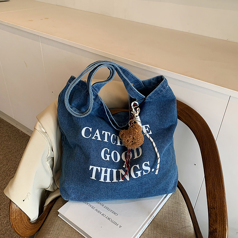 Bolsa de vaquín casual americana para estudiantes universitarios de clase viaje de compras letras de viento perezoso portátil gran capacidad bolso de hombro