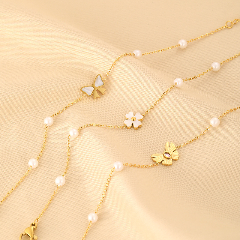 Estilo japonés y coreano Luz de lujo INS de moda Concha perla pulsera hembra mariposa trébol personalidad todo fósforo pulsera de acero inoxidable