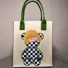 Color-blocked green grid bear-felt bag