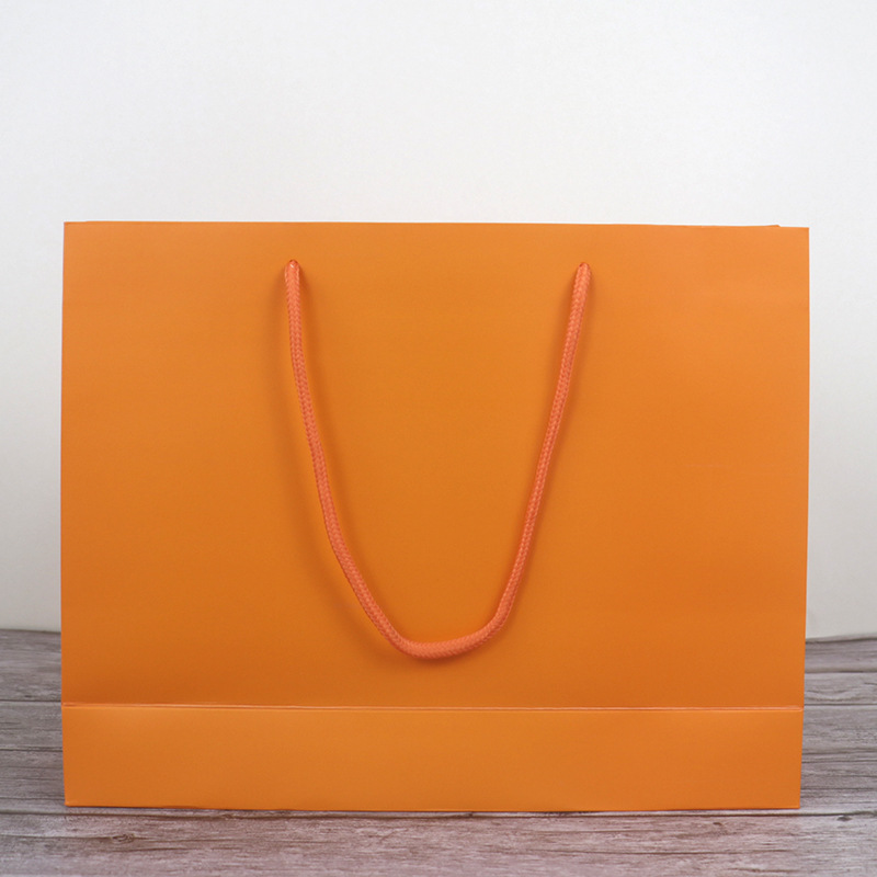 衣服店购物纸袋牛皮纸礼品袋时尚大牌手提袋橘色女装包装袋子批发