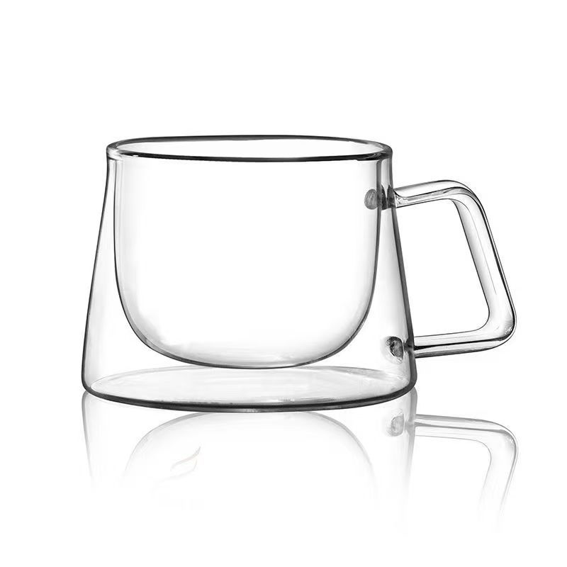 Transfronterizo de alto borosilicano de alto valor facial taza de café de leche resistente a los trópicos con mango taza acompañante de mano regalo explosivo doble aislamiento de vidrio