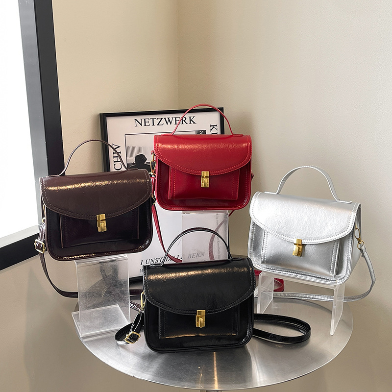 Bagos portátiles de estilo extranjero 2025, primavera nueva moda de nicho, bolsos de hombro de moda, bolsos de bloqueo personalizados, bolsos de mujer de tramo inclinado